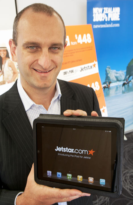 Bruce Buchanan, CEO Jetstar Group, displays iPad as the airline rolls out the new in-flight technology today.